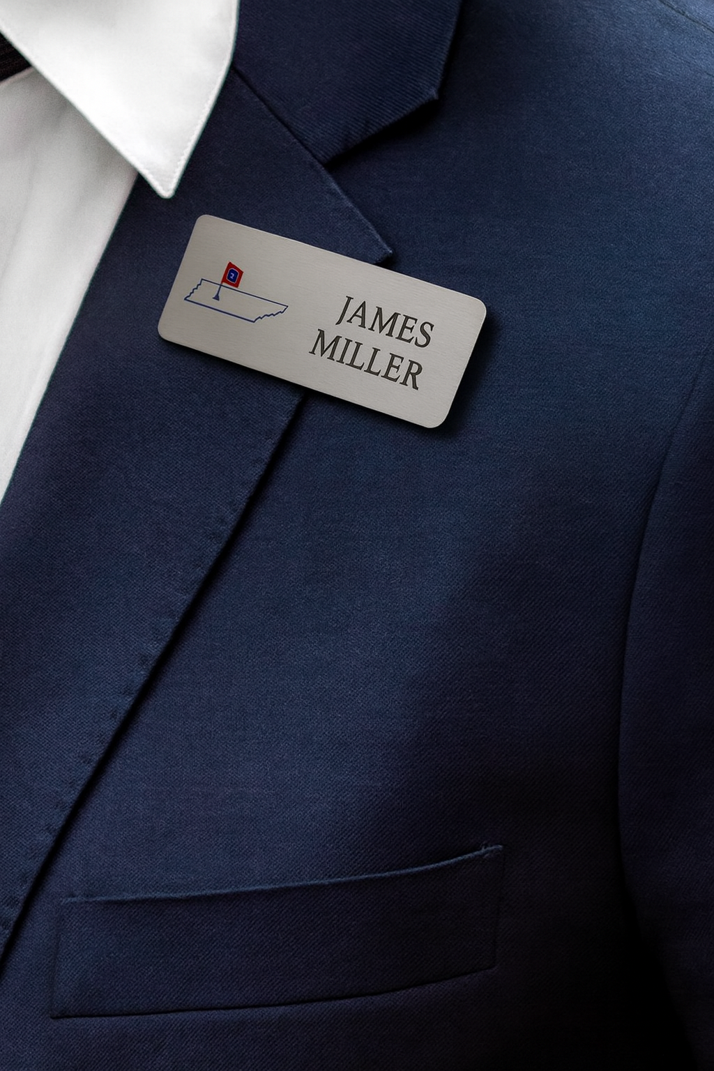 Name tag on navy blue suit jacket.