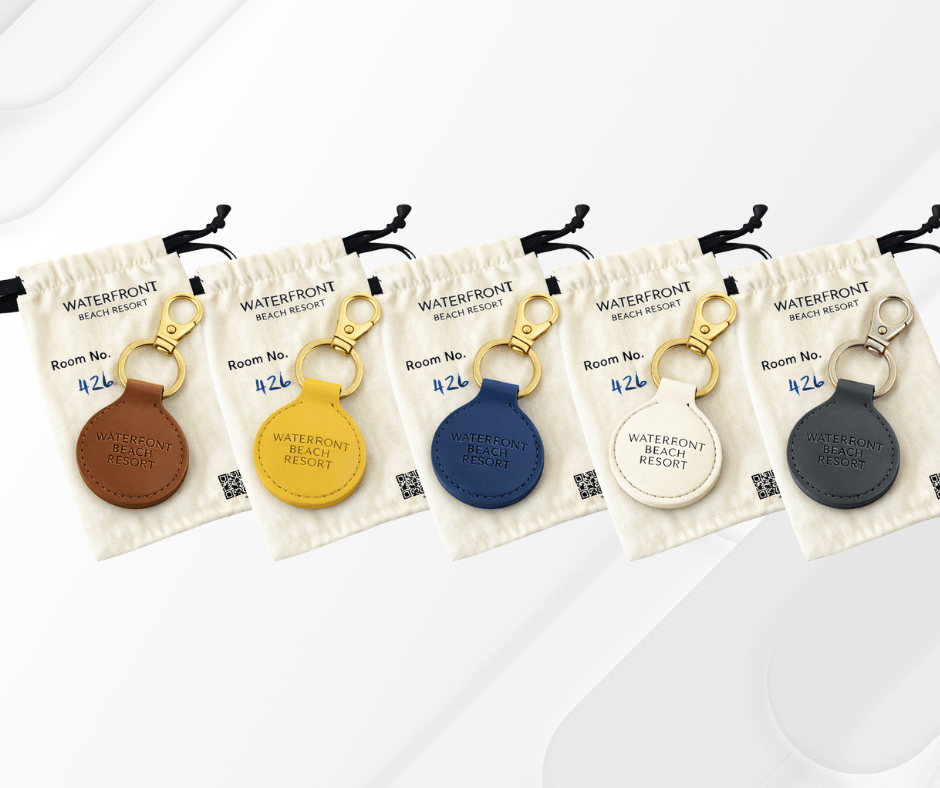 Five different colored keychains with labels.